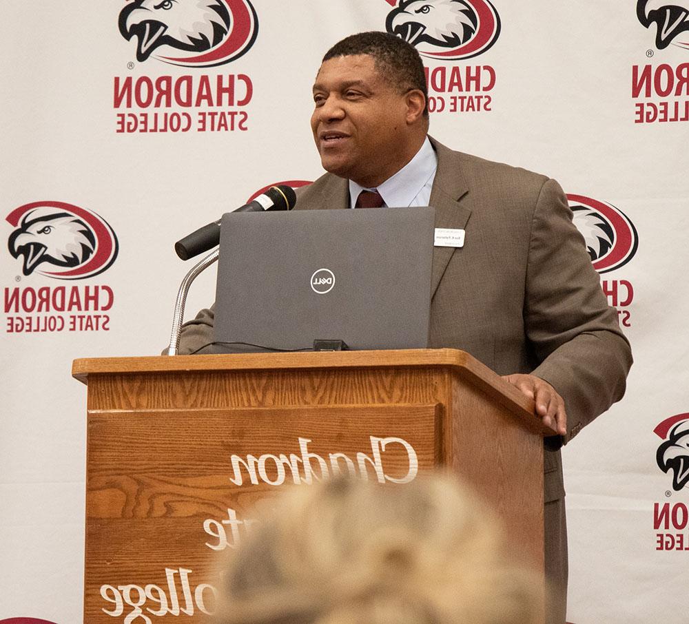 Adult male speaking at a podium